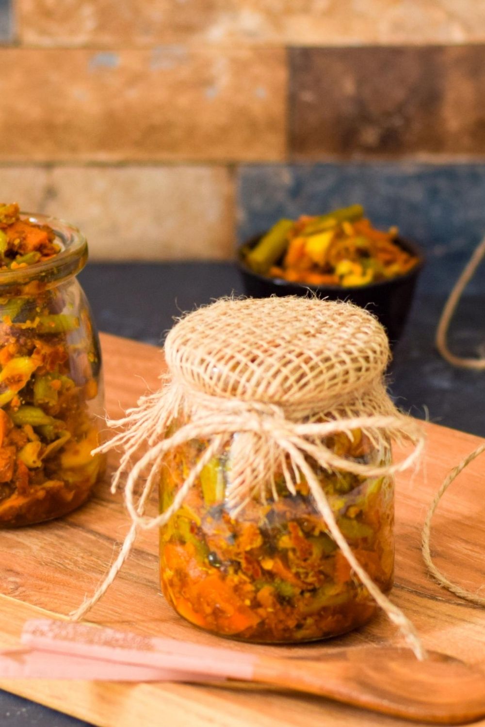 Colorful mixed vegetable pickle with carrots, cauliflower and green chilies in traditional glass jar