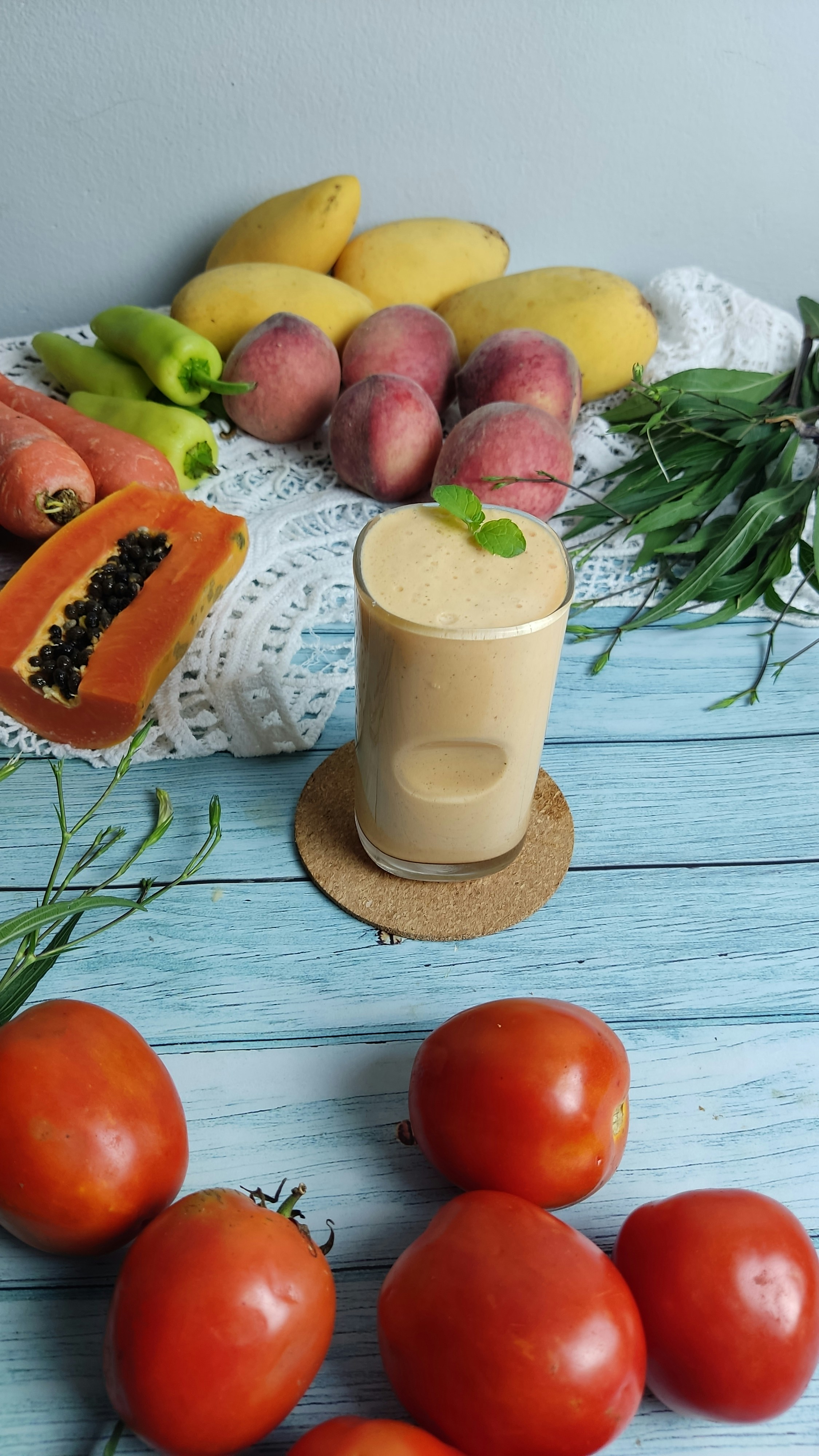 Creamy smoothie with amla murraba in glass with fresh fruits and mint garnish