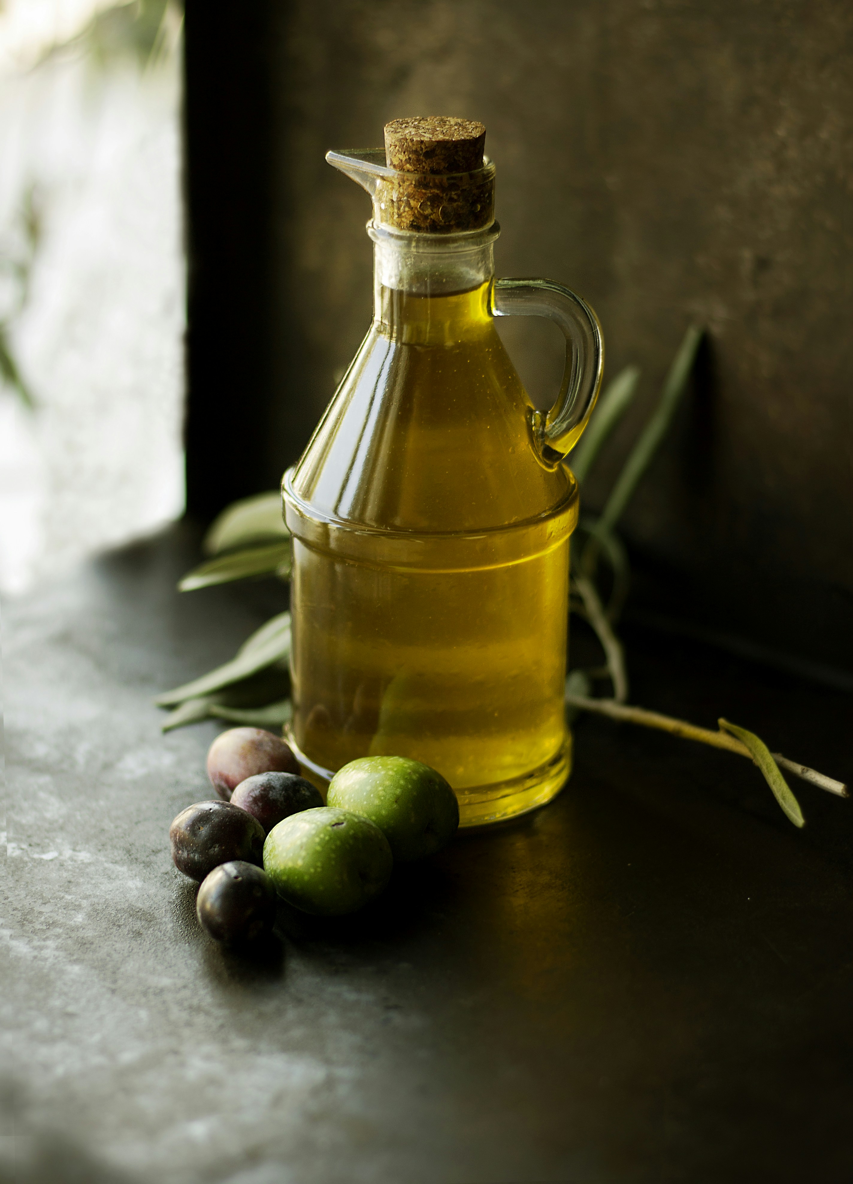 Golden mustard oil in traditional glass bottle with mustard seeds scattered around